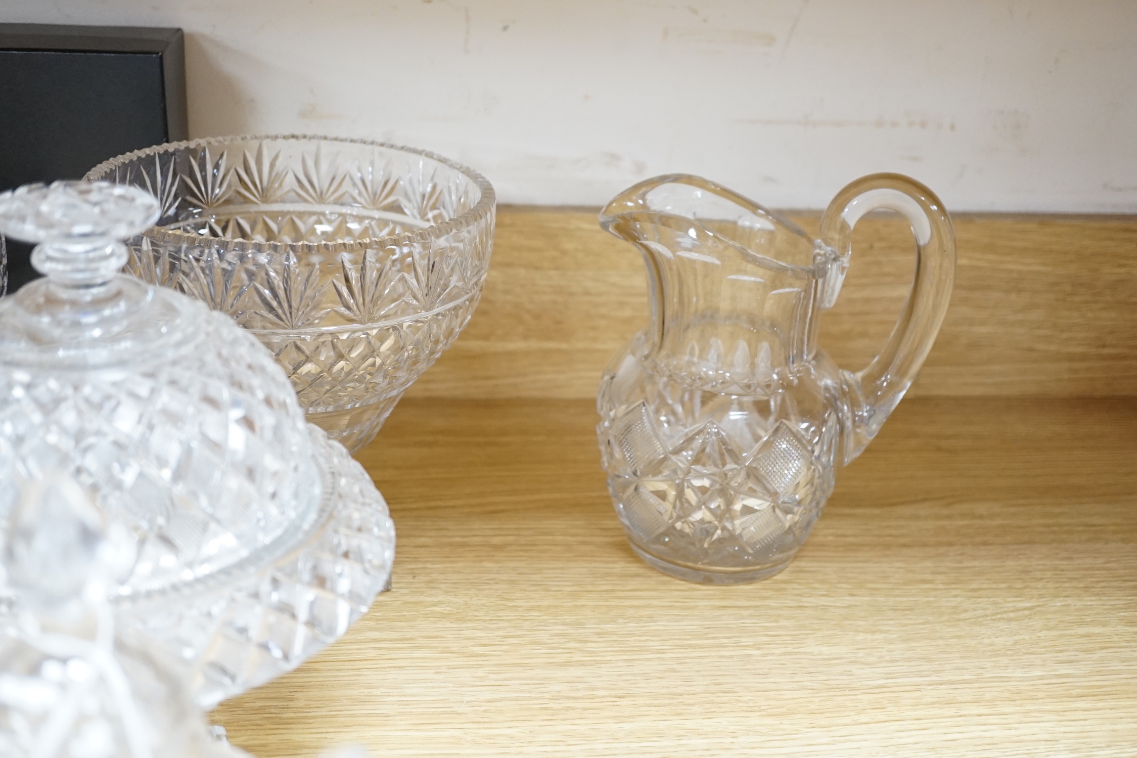 Ten cut glass items including; four pedestal bowls and covers, two oval, pedestal dishes, a two oval, pedestal dishes, a jug, a pair of glasses, etc., tallest, 26cm